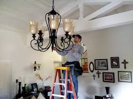 electrician installing chandelier